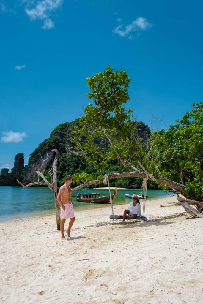 Koh Phakbia Island is near Koh Hong Krabi, a beautiful white sandy beach in Krabi Thailand. Young Asian woman and European men on the beach.