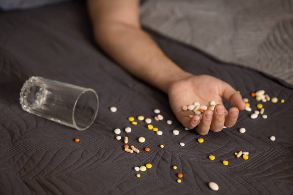 Addiction Causes suicide-attempt-male-hand-with-pills-2025-01-09-02-07-13-utc (1)