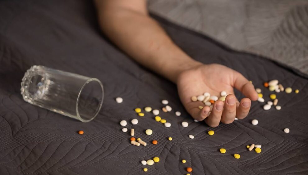 Addiction Causes suicide-attempt-male-hand-with-pills-2025-01-09-02-07-13-utc (1)