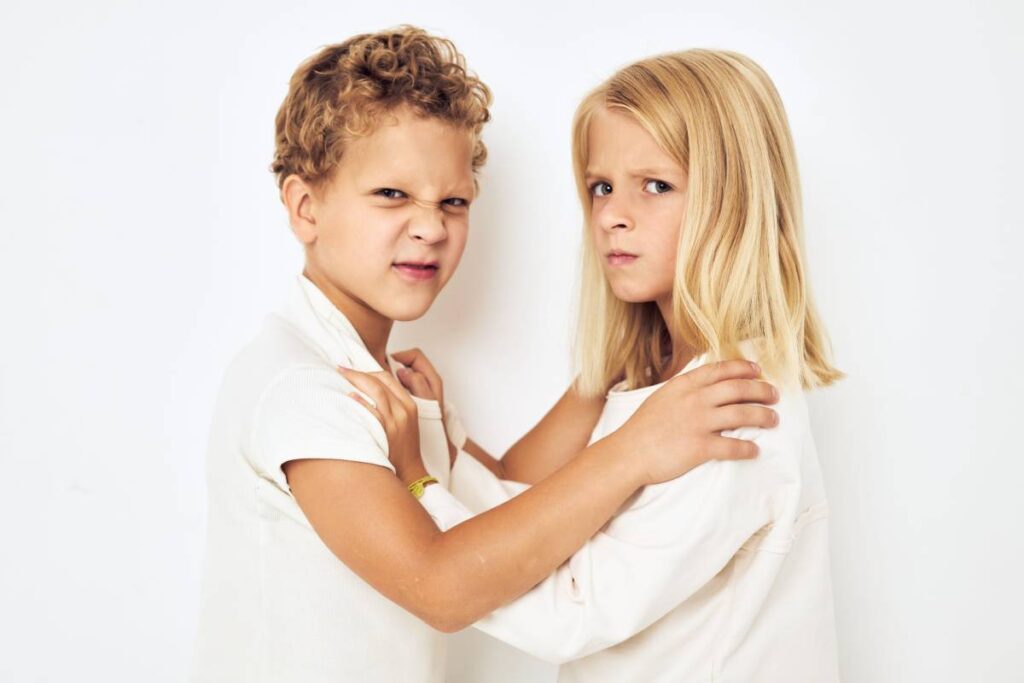 The boy is offended by the little girl fight naughty isolated background