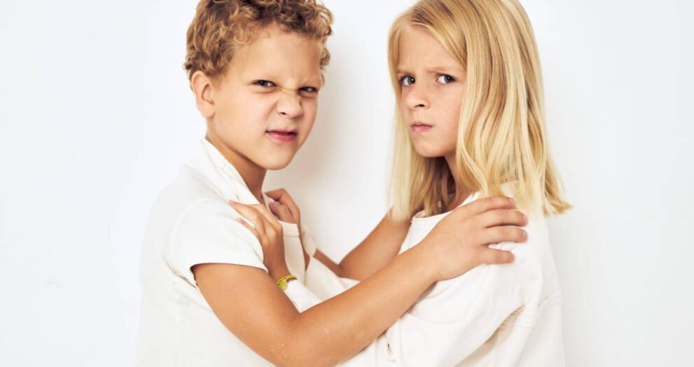 The boy is offended by the little girl fight naughty isolated background